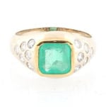 14k gold ring with diamonds and an emerald