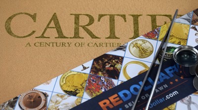 Cartier book with loupe and redollar flyer