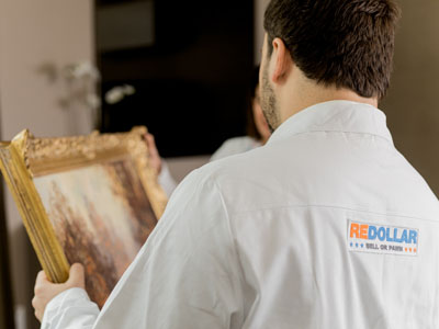 stock image: art and antiques appraiser working on oil painting