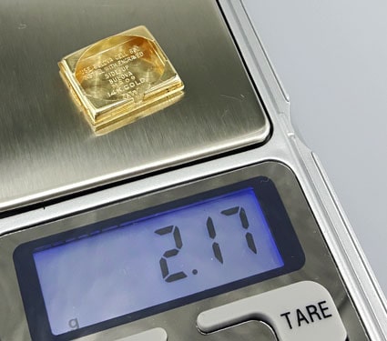 weighing a 14k Bulova marked watch back with scale