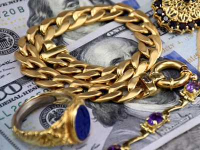 gold jewelry on bank notes