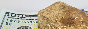 melted gold ingot on 100 dollar bill