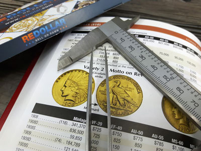 stock image: $10 gold coin, coin book, tweezer and caliper