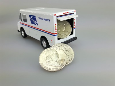 stock image: USPS truck delivering Franklin silver coins
