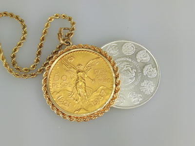 stock image: Pesos gold coins and silver coin from Mexico