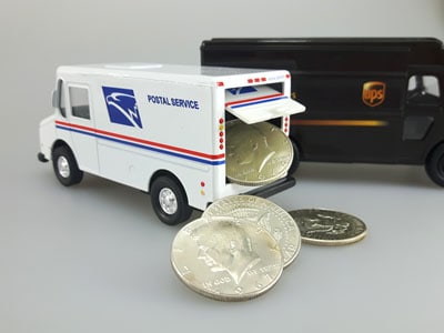 stock image: UPS and USPS truck shipping silver coins
