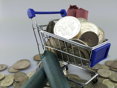 stock image: coin rolls and silver coins in shopping cart, basket