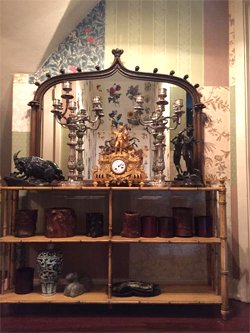 Antique cabinet with watch, crystal, and other collectibles.