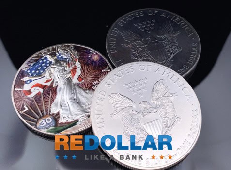 A colored, a toned, and one uncirculated Silver Eagle shining together.