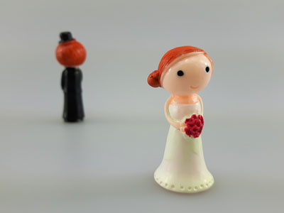 stock image: bride walking away from groom with bouquet of flowers