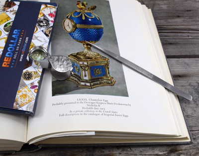 redollar advertising with Fabergé book and loupe