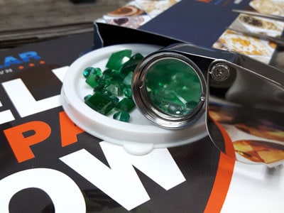 stock image: sell and buy emeralds online, gem magnifier