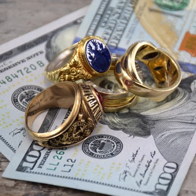 mixture of modern and vintage gold rings on US dollars