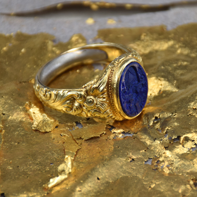 18K gold ring on gold leaf