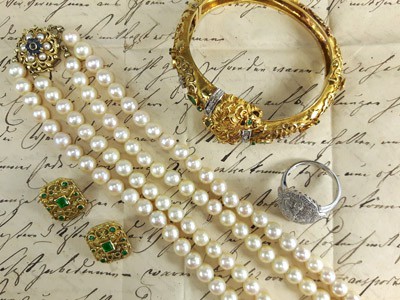 stock image: pearl necklace, gold bangle, emerald earrings, diamond ring