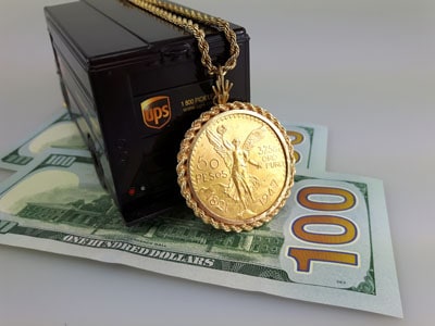 stock image: 50 Pesos gold coin, Pesos coin pendant, UPS, buy and sell