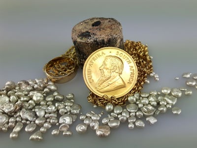 stock image: Krugerrand, melted gold, silver granules