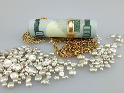 stock image: wedding ring, 100 dollar bill, gold necklace