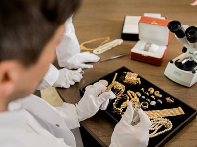 stock image: jewelry appraisers, gold bangles, rings