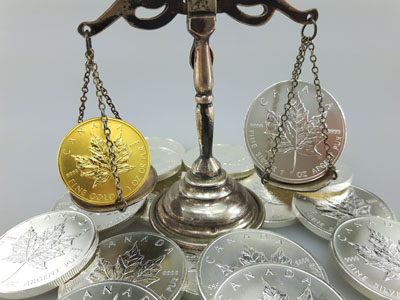 stock image: weighing Maple Leaf coins made of gold and silver