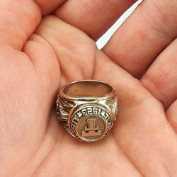 Texas Tech University gold ring in hand