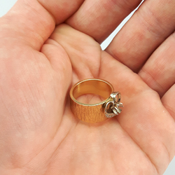 a vintage women's ring made of gold in a hand