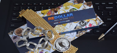 jewelry and silver coin on redollar envelope