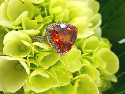 stock image: mandarin spessartite garnet and diamond ring