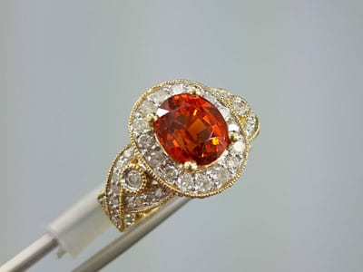 stock image: mandarin spessartite yellow gold and diamond ring