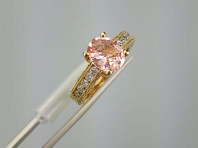 stock image: Padparadscha sapphire yellow gold ring, diamonds