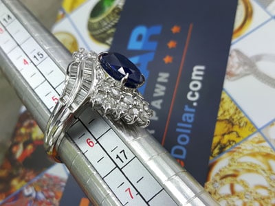 stock image: ring measurement tool, sapphire diamond gold ring