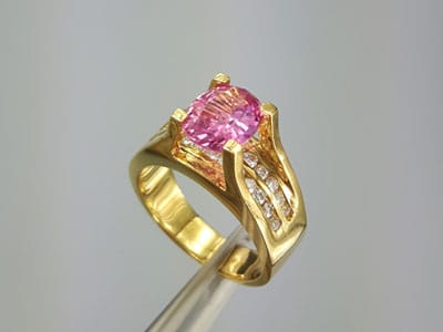 stock image: pink sapphire, yellow gold diamond ring