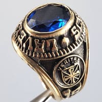 John Lavelle school ring featuring synthetic Sapphire and Veritas coat of arms.