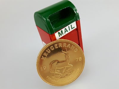 stock image: Krugerrand coin and mail box, mail Krugerrand