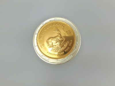 stock image: Krugerrand gold coin on American silver Eagle