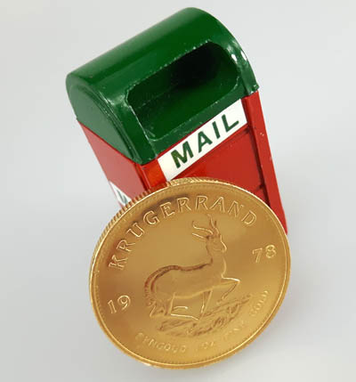 mailbox with gold coin promoting mail in gold buyer service