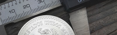 caliper in use to measure Mexican silver Libertad 