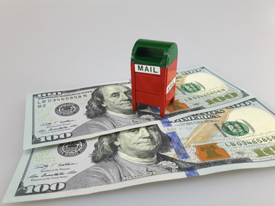 stock image: two 100 dollar bills and USPS mail box for money