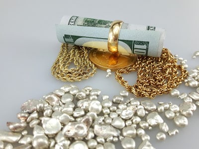 stock image: bundle of money, 100 dollars, gold and jewelry