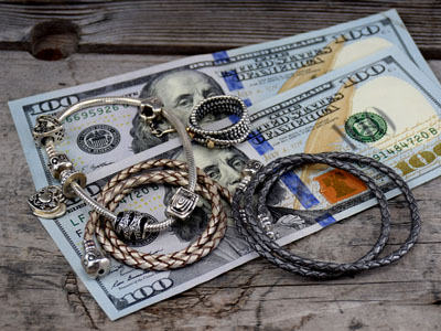 stock image: Pandora silver bracelet, leather bracelet and ring