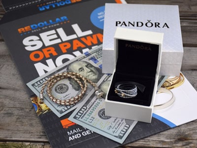 stock image: Pandora ring in box, bracelet, dollars, boxes