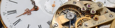 parts of a gold pocket watch: movement and dial