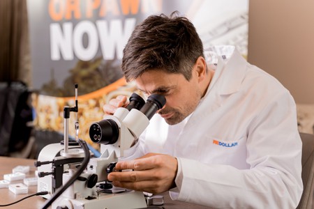 redollar expert checking gemstones with microscope