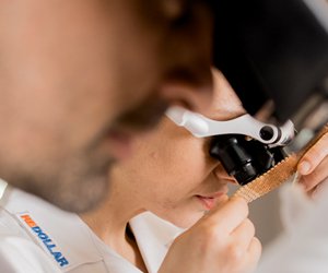 reDollar experts checking jewelry with a loupe