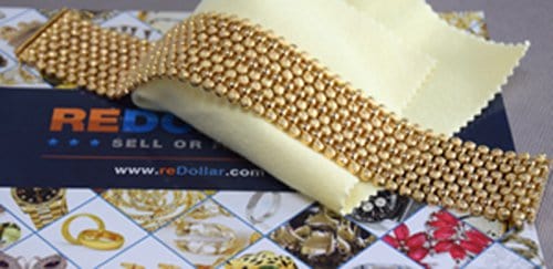 redollar advertisement with 18 karat gold bracelet