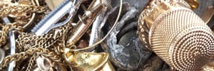 scrap gold jewelry, a gold thimble and melted gold