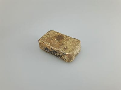 stock image: scrap gold melted into gold bar