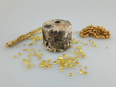 stock image: gold nuggets, jewelry spread around melted scrap