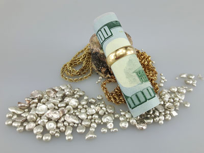 stock image: scrap gold, 100 dollar bundle and jewelry