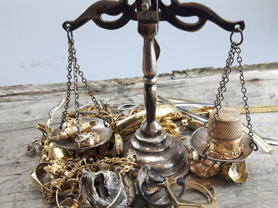 stock image: weighing scrap gold with vintage scale